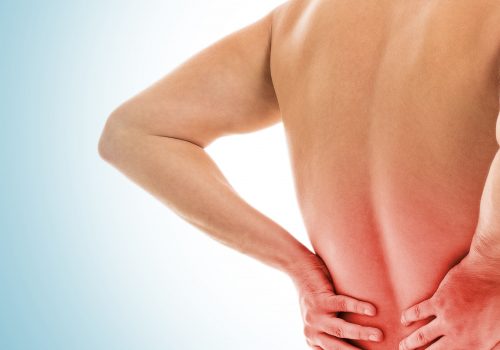 Man is touching his back because it aches